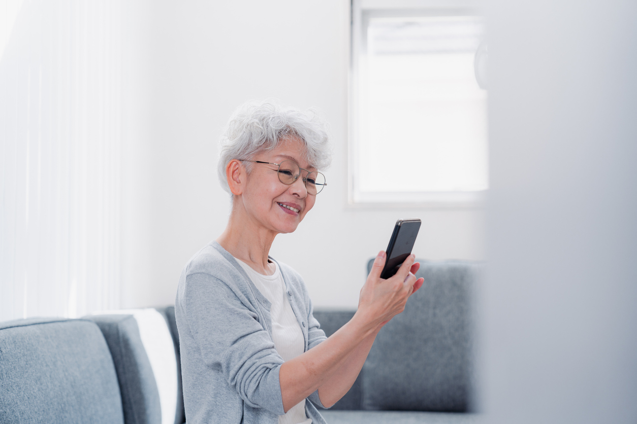 Senior woman using her smartphone with a smile